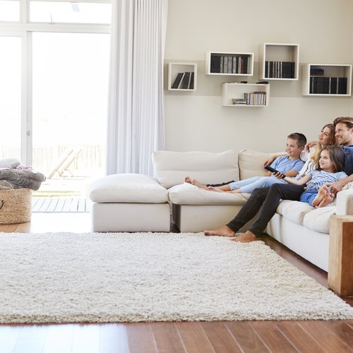 relaxing on a white sofa with an area rug at your feet from Roedigers Custom Flooring in Celina, OH