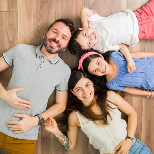 family relaxing on the floor provided and installed by Roedigers Custom Flooring in Celina, OH